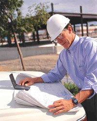 Qualifications of ICCA Members Foreman with Hard Hat Studying Blueprints